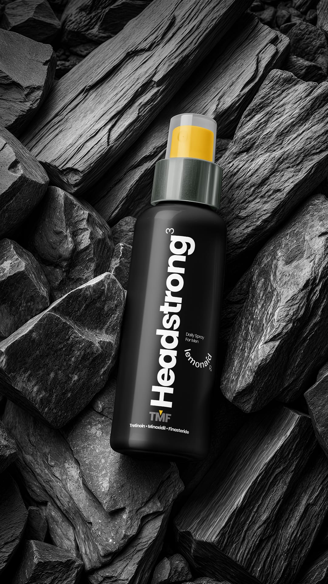 Headstrong Spray bottle against dark stone background